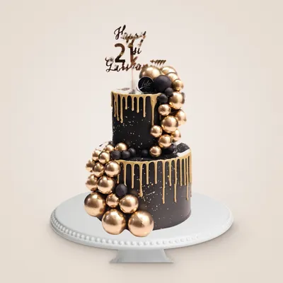 Two-tier black and gold 21st birthday cake with gold drip and gold spheres by LÉLE Bakery