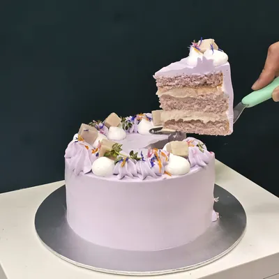 Orh Nee yam cake with purple cream, sliced to show the yam layers