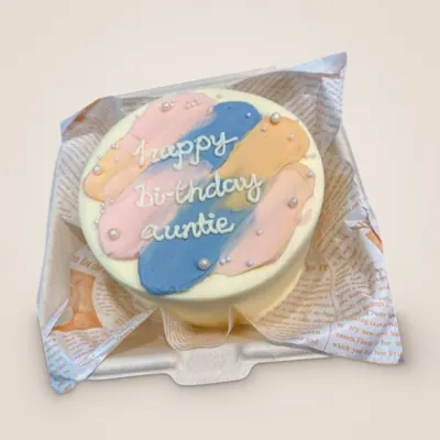 Pastel pink, blue and yellow bento cake piped with Happy Birthday Auntie
